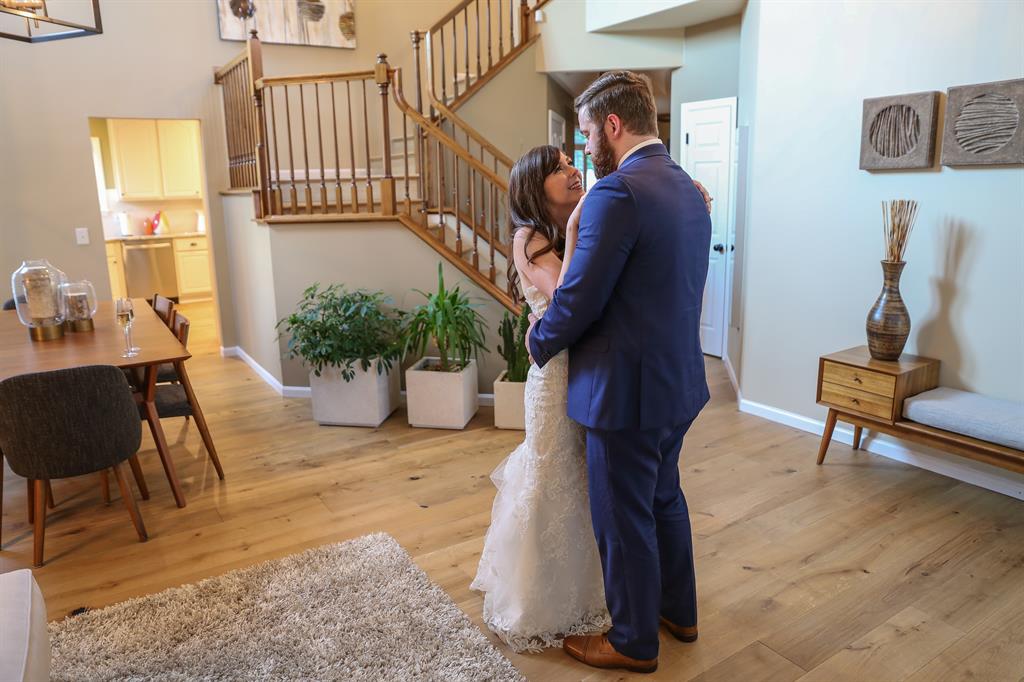 bride and groom dancing on the wood floor in their home