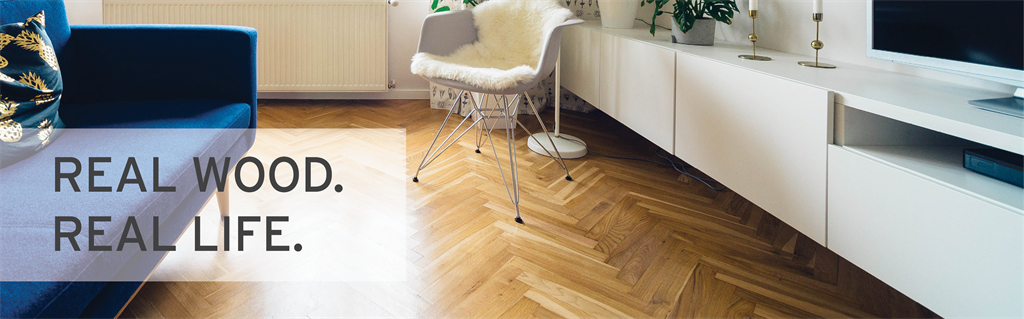hardwood flooring in a living room that has been placed in a herringbone pattern