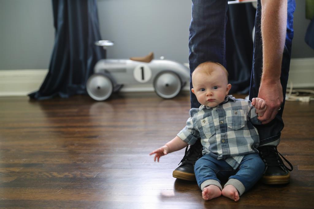 baby sitting on a wood floor